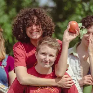 Two students picking apples.